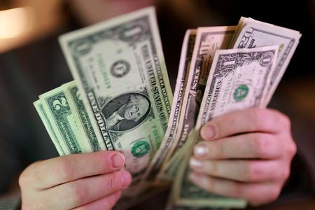Dollar holds firm at nearly two-week high as Middle East hostilities lift oil