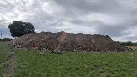 Tonnes of rubble including 'bits of old toilets' being dumped in village, residents claim