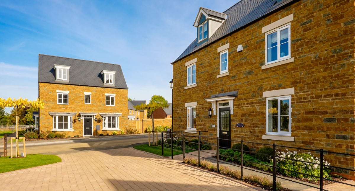 Britain’s biggest housebuilder slows land buying and cuts home sales outlook