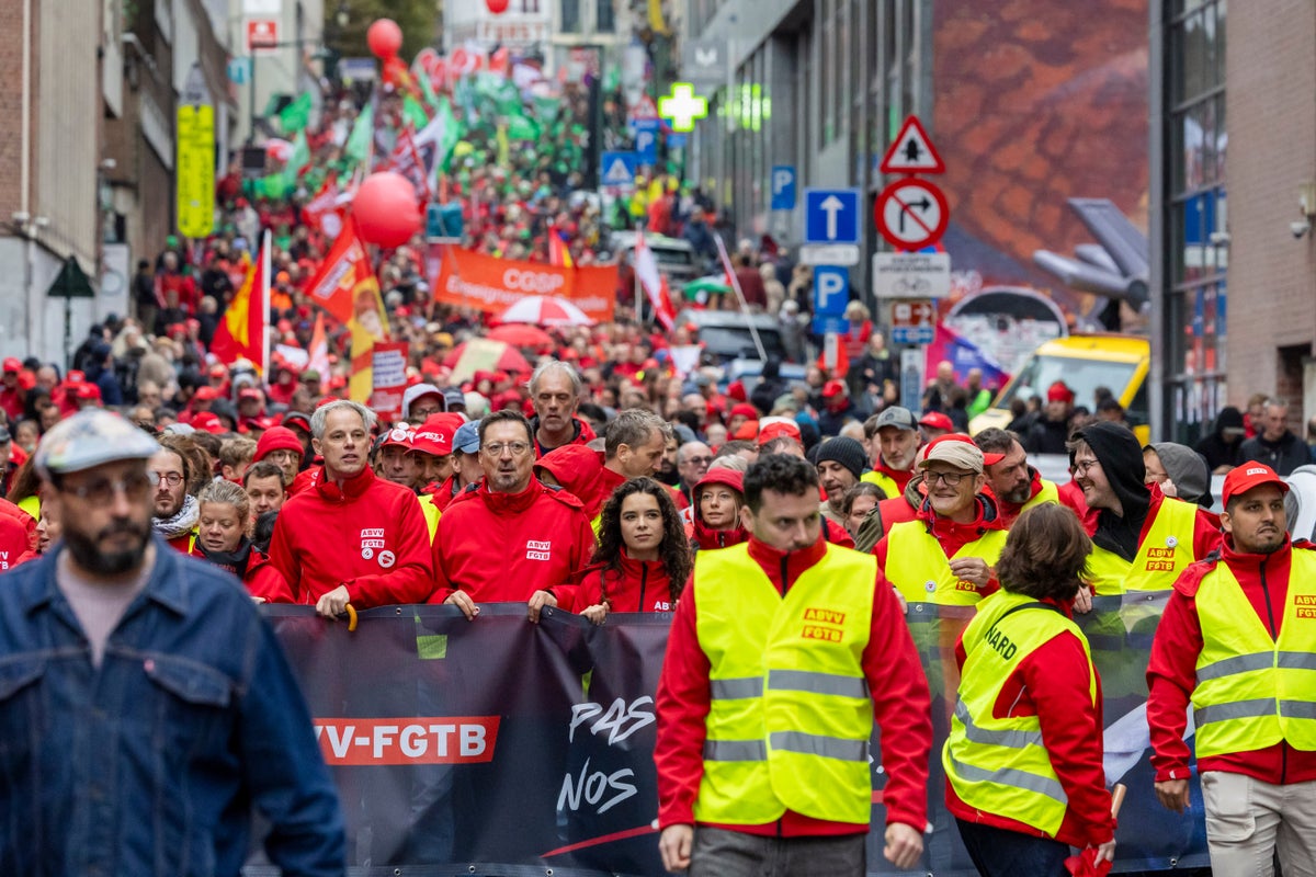 Police and masked protesters clash in Brussels as anti-austerity rally disrupts city